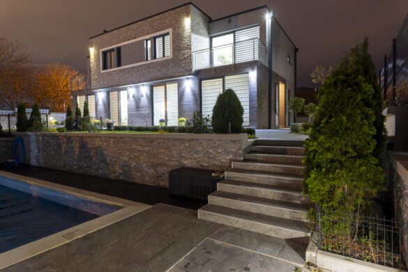 Modern family villa with swimming pool at night